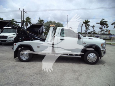 Ram 4500 tow truck side view showing single cab, white paint, wheel-lift equipment, J98294FM stock number plate.