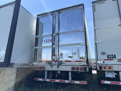 Rear view of a 2022 Utility 3000R trailer showing closed double doors with metal latches, rear bumper, and reflective tape. VIN not visible, stock UE11634 in listing.