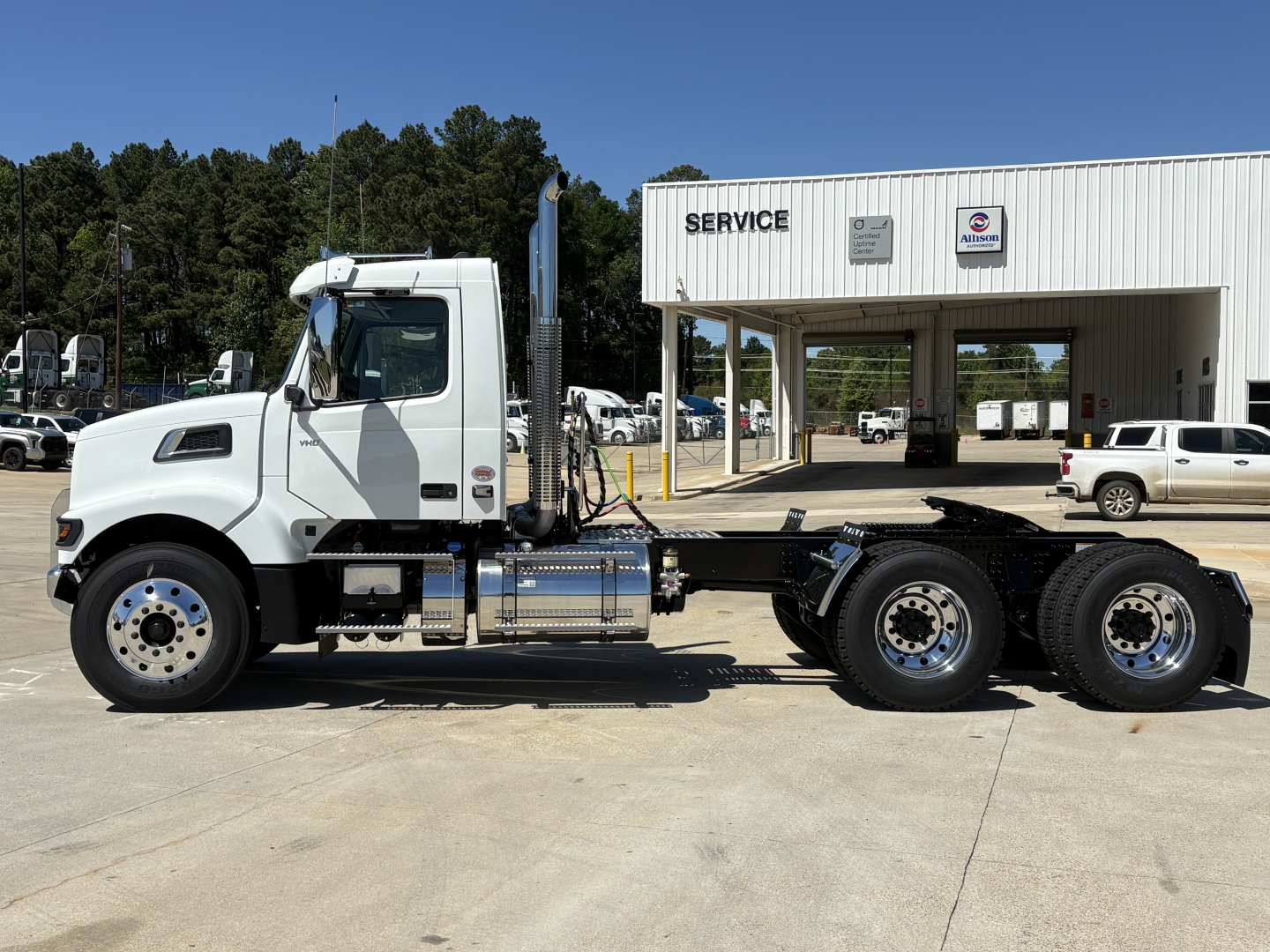 Volvo VHD64FT300 conventional daycab tractor in side profile showing cab, fuel tanks, and chassis with rear dual axles.