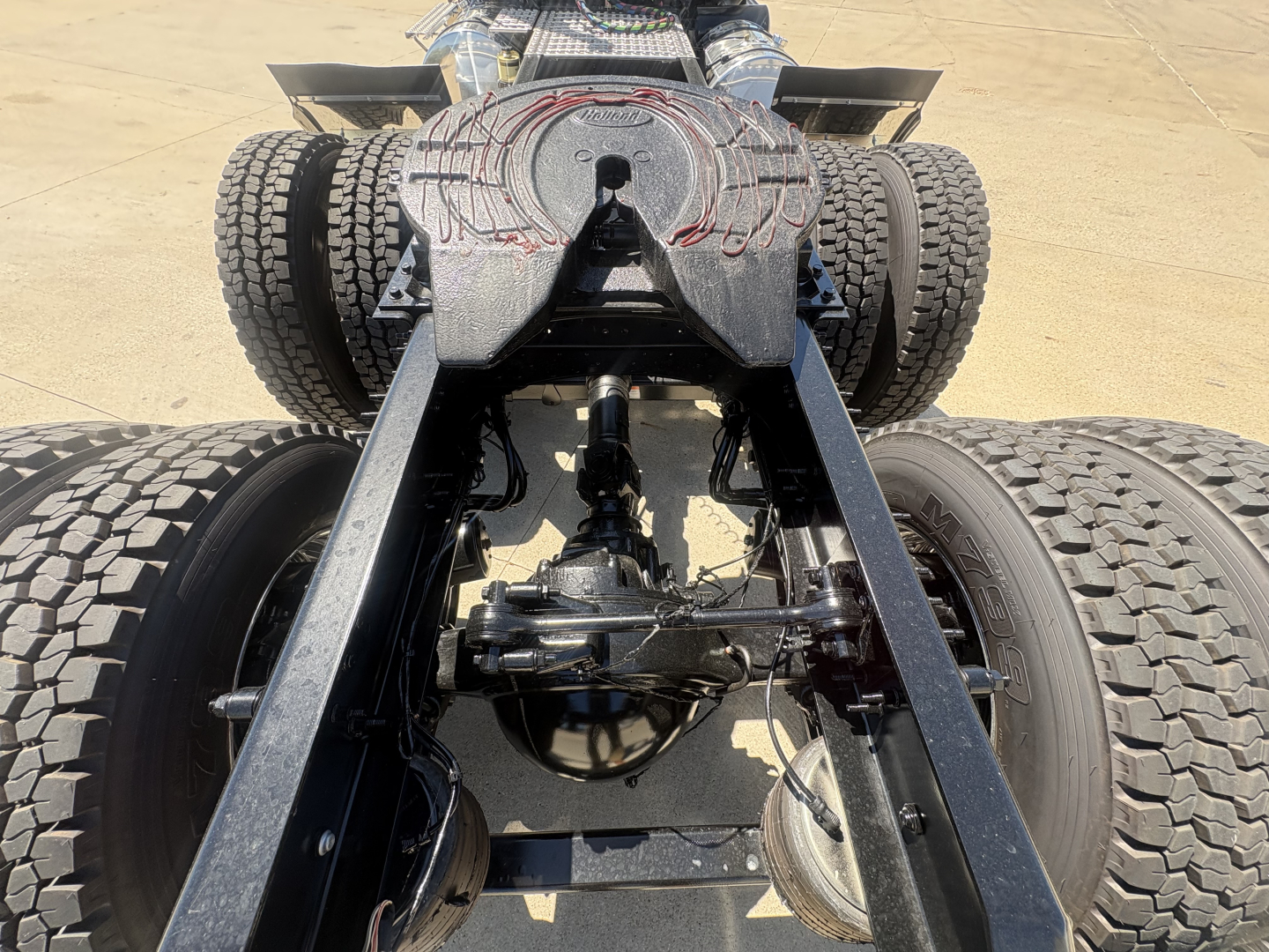 Volvo truck rear chassis showing dual rear axles and fifth-wheel hitch with visible drivetrain and suspension components.