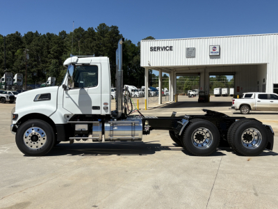 Volvo VHD64FT300 conventional daycab tractor in side profile showing cab, fuel tanks, and chassis with rear dual axles.