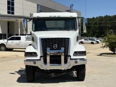 Volvo VHD64FT300 conventional daycab truck front view showing grille, bumper guard, and side mirrors.