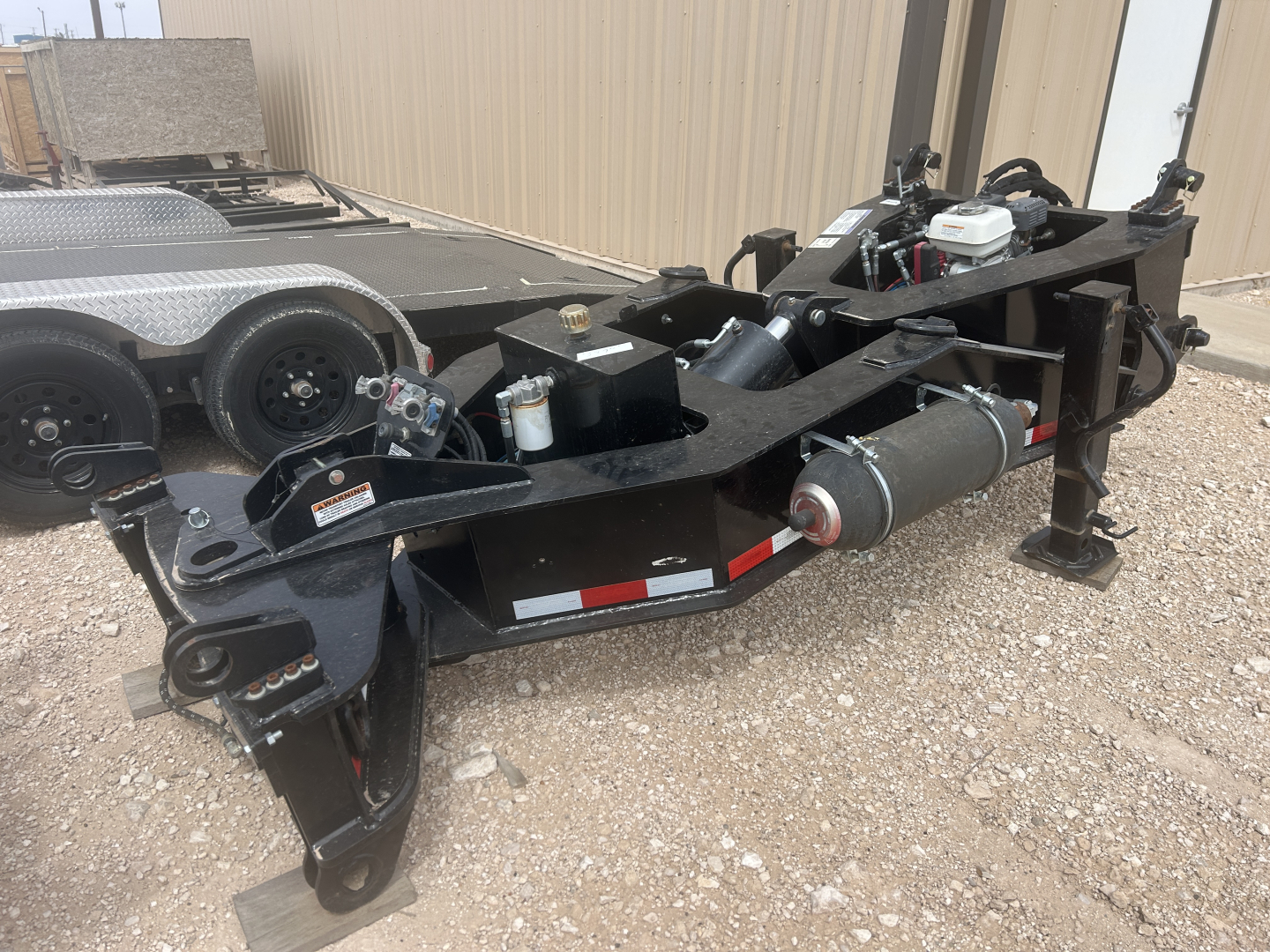Load King SB141/2-NS-43 trailer chassis showing hydraulic pump, tires, and hardware with black frame and white engine label.