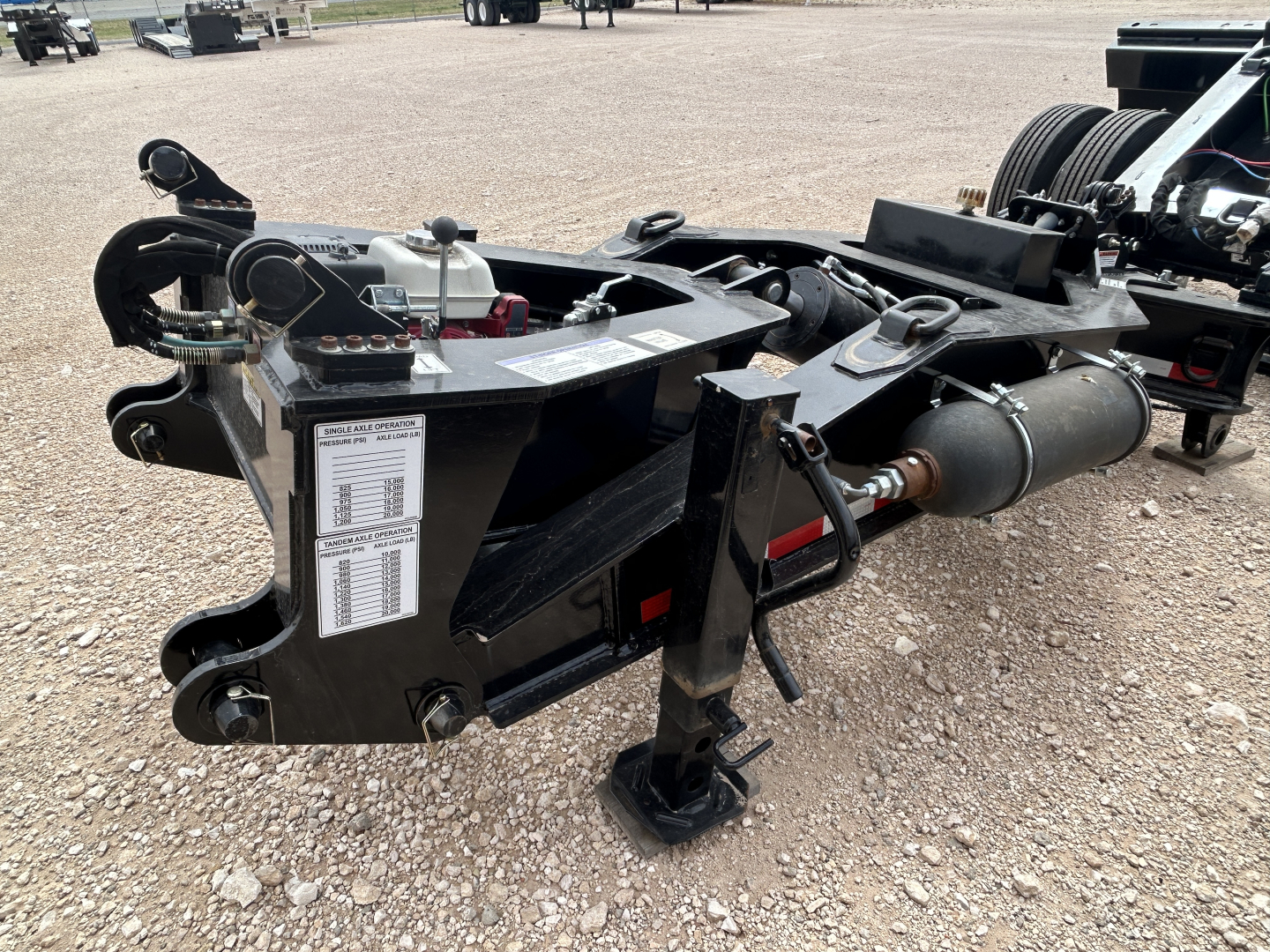 Load King trailer hitch assembly showing hydraulic line, winch, and frame with label plate visible.