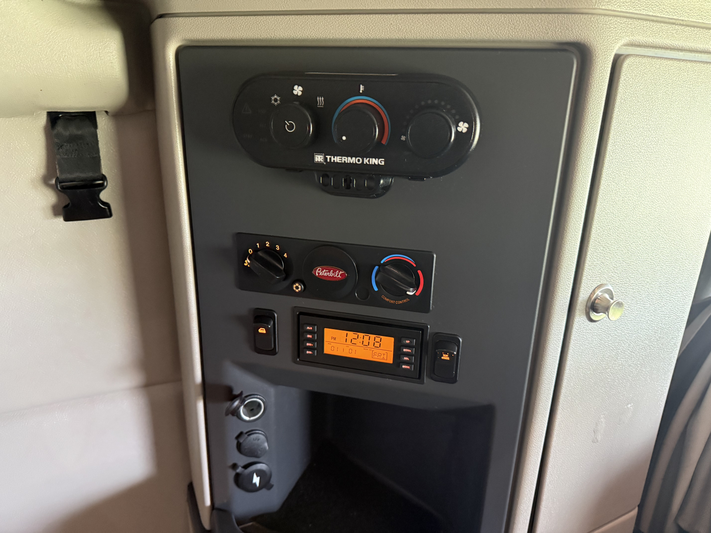 Peterbilt 579 dash area showing climate controls, radio, and storage compartment in cab interior