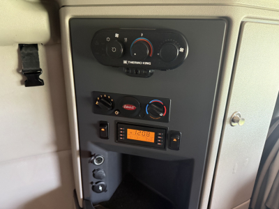 Peterbilt 579 dash area showing climate controls, radio, and storage compartment in cab interior