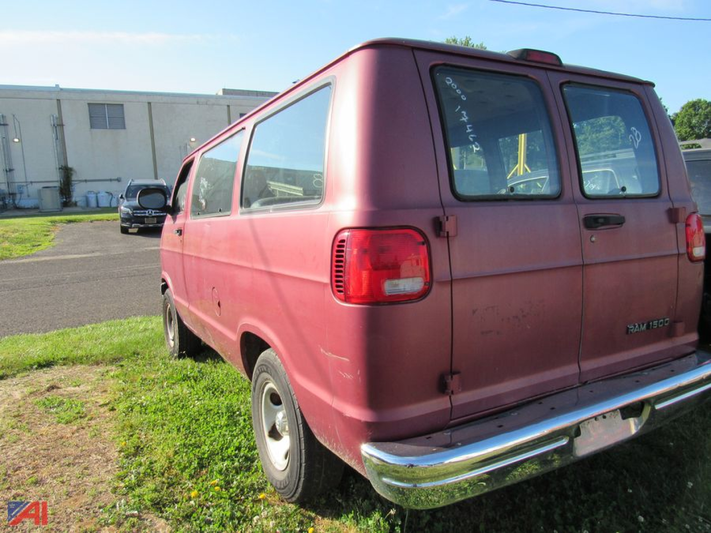 Dodge Ram full-size van rear and passenger side showing maroon exterior, dual rear doors, and chrome bumper.