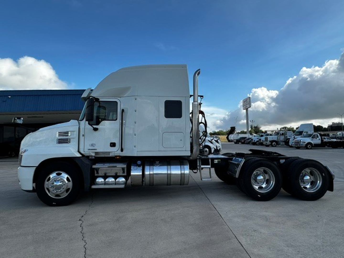 Mack AN64T70 truck tractor side view showing fuel tanks and rear dual axles.