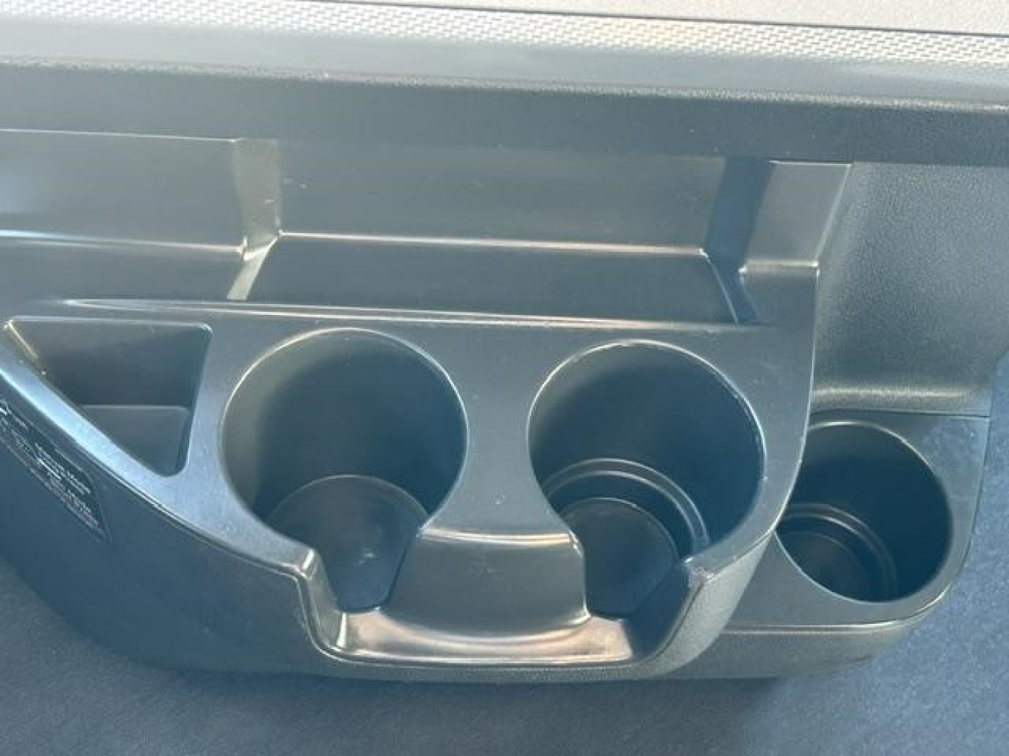Freightliner Cascadia cup holder and dashboard console showing cup slots and circular holders.