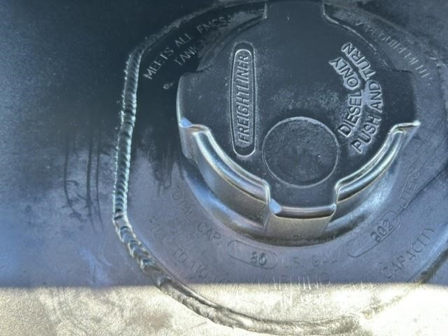 Fuel cap on Freightliner Cascadia showing diesel fueling area.
