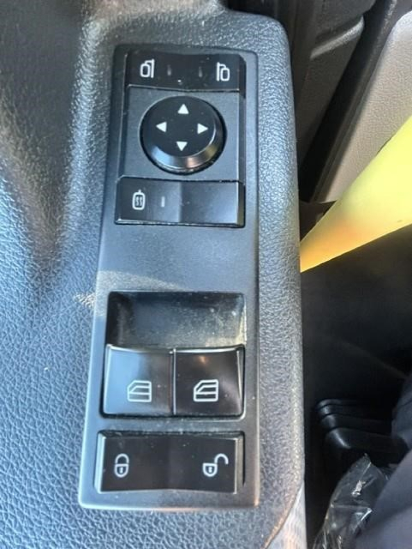 Freightliner Cascadia interior control panel showing window lock switches and mirror adjust dial.