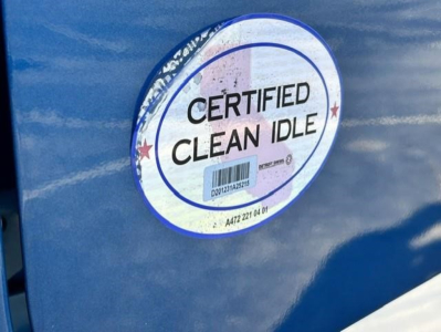 Sticker on blue Freightliner with 'CERTIFIED CLEAN IDLE' round label.