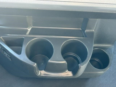Freightliner Cascadia cup holder and dashboard console showing cup slots and circular holders.