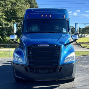 Blue Freightliner Cascadia truck front view showing grille, headlights, side mirrors, and hood with Freightliner emblem.