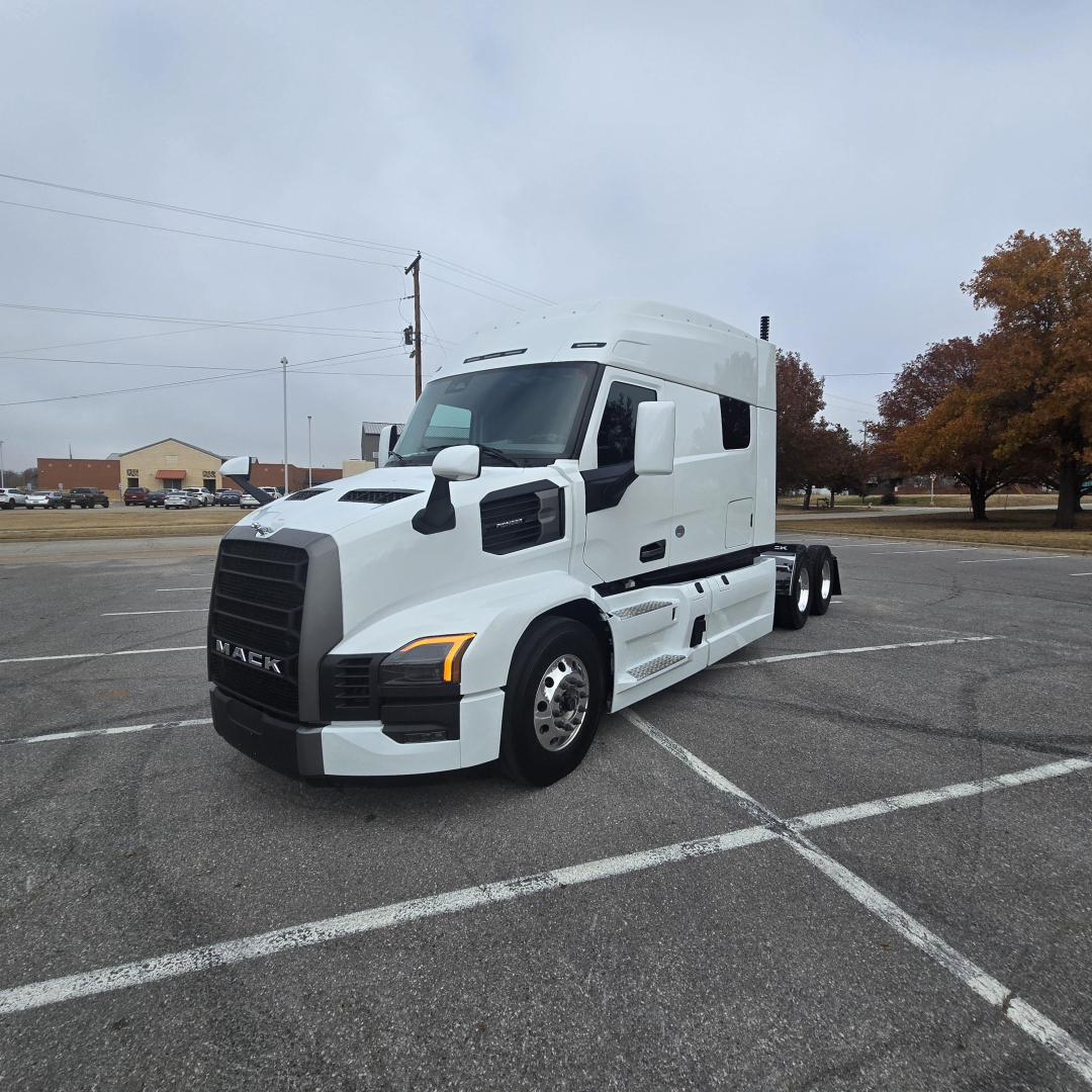 Mack PR64T76M truck in a parking lot showing front and side view with white cab and black grille.
