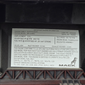 Engine information placard on Mack MP13 engine showing specifications and labels inside a truck engine bay.