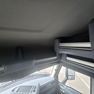 Cab interior of a 2026 Mack PR64T76M sleeper truck showing overhead bunk area and dashboard edge.