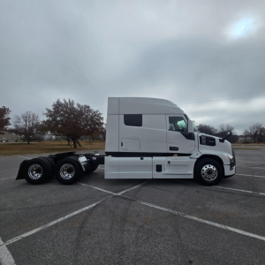 White Mack PR64T76M tractor in side profile view showing cab and rear axles, no visible text labels.