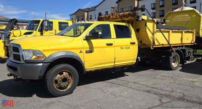 Dodge Ram 5500 chassis cab dump truck with plow in a parking lot, yellow cab, front grille, and dumping bed visible.