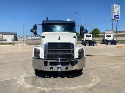 Mack AN64T daycab front view showing white cab, black grille, chrome bumper, and Mack emblem.