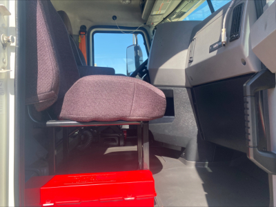 Interior cab view of a 2021 Mack AN64T truck showing driver seat and dashboard with steering wheel and passenger seat.