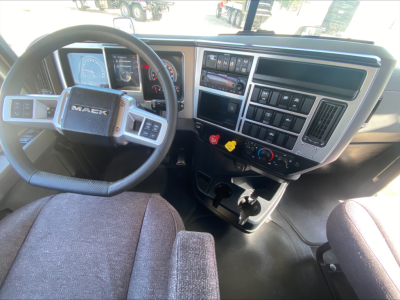 Mack AN64T truck interior showing steering wheel and dashboard controls with center stack and climate controls.
