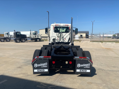 Rear view of a white 2021 Mack AN64T daycab tractor showing dual rear mudflaps with Bruckner's Equipment logos and ENID text.