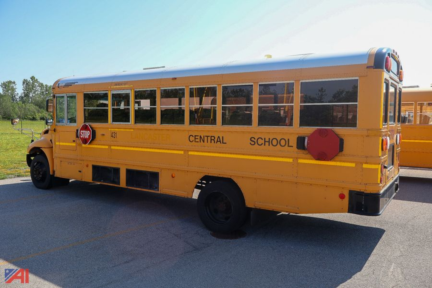 IC Corporation CE Series school bus side view showing central school district lettering and emergency access hatch.