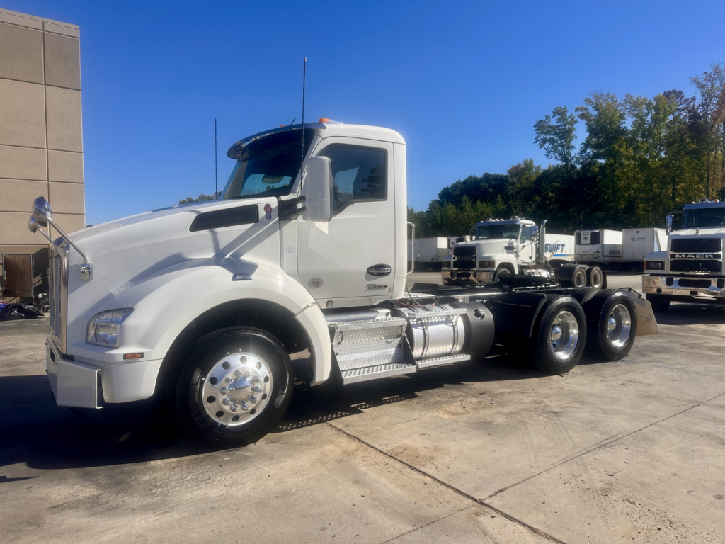 Kenworth T880 conventional daycab tractor, white exterior, 2022 model, side view with fuel tanks and dual rear axles, VIN 1XKZD49X7NJ103571 visible in listing context