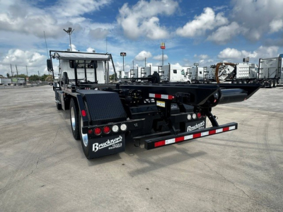 Back of 2026 Mack GR64B roll-off truck showing rear bumper and taillights.