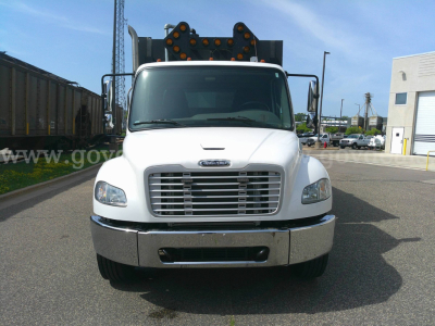 Front view of a white 2018 Freightliner M2-106 service truck showing grille, bumper, and dual mirrors.