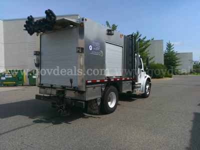 Service/utility truck rear and side view showing equipment compartments on Freightliner M2-106.