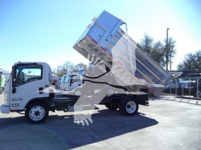 Isuzu NPR HD dump truck side view with bed raised, white cab, dumping container in operation.