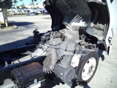 Isuzu NPR HD engine bay with hood open showing engine components and air filter housing.