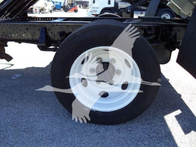 Isuzu NPR HD chassis showing wheel with white steel rim and exposed frame.