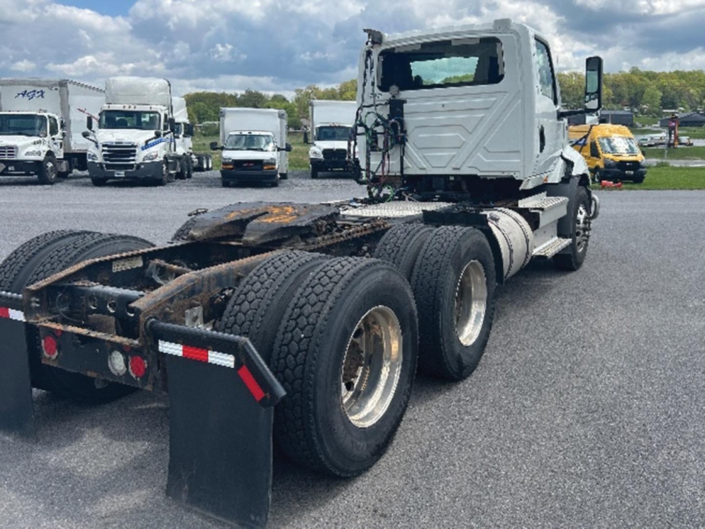 Tractor truck chassis and cab view showing rear five wheels and fifth wheel, International RH613 2019 in-use vehicle.