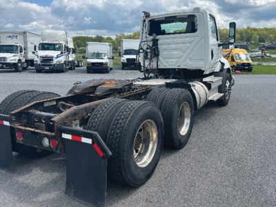 Tractor truck chassis and cab view showing rear five wheels and fifth wheel, International RH613 2019 in-use vehicle.