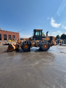 Hyundai HL740-9 wheel loader in an outdoor lot, side view with bucket attachment, clear blue sky, stock number 30360.