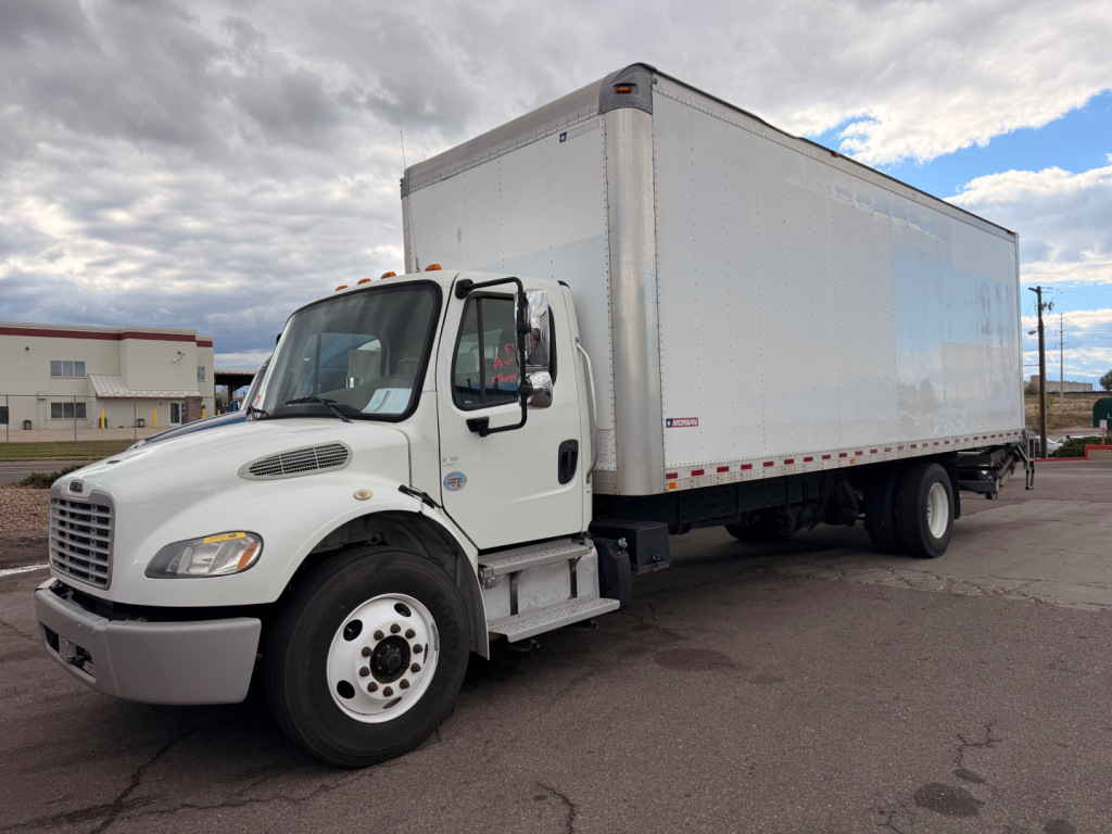 Freightliner M2-106 box truck in-service showing cab and long box with white exterior.