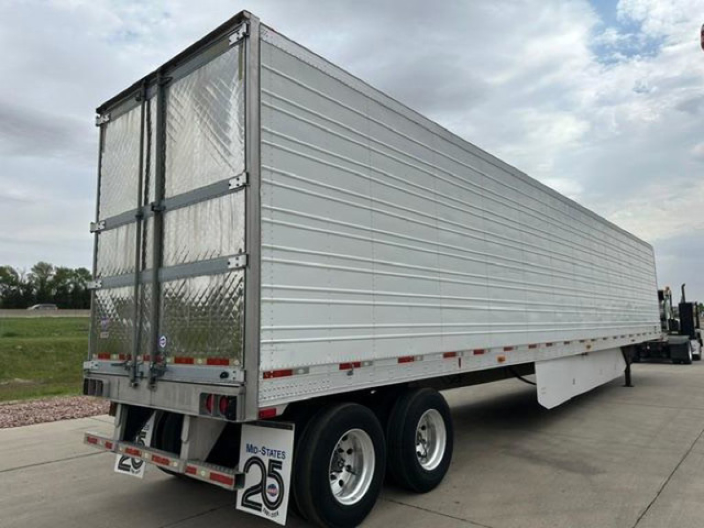 Trailer rear and side view of a 2016 utility refrigerated trailer showing metal ribbed cargo area and dual rear doors.