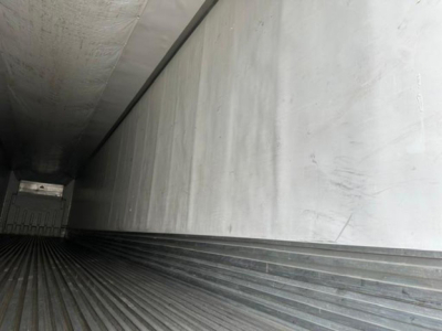Trailer interior cargo area showing ribbed floor and rear door, 2016 utility reefer in-service.