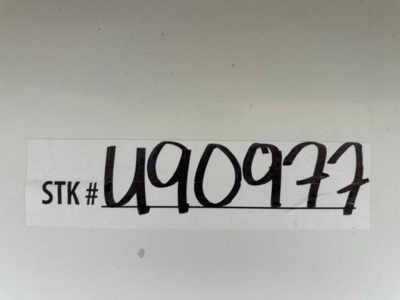 Sticker with STK # U40977 handwritten in black on white label.
