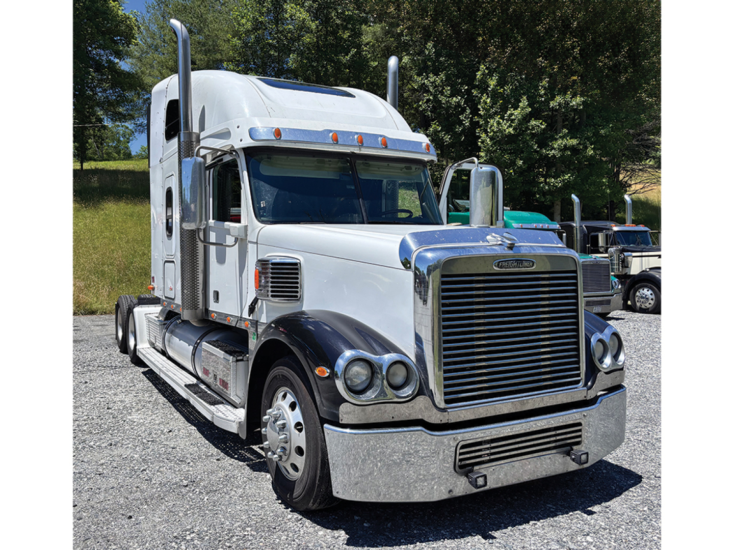 Freightliner Coronado semi-truck tractor cab in profile view with chrome grille, sleeper cab, and dual exhaust stacks.