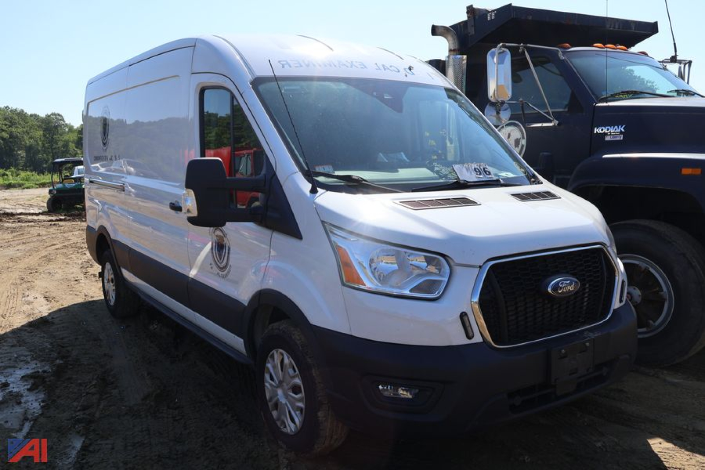 Ford Transit 350 cargo van side/front view showing white exterior, black grille, side mirrors, and a windowed cargo area.