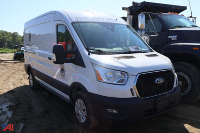 Ford Transit 350 cargo van side/front view showing white exterior, black grille, side mirrors, and a windowed cargo area.