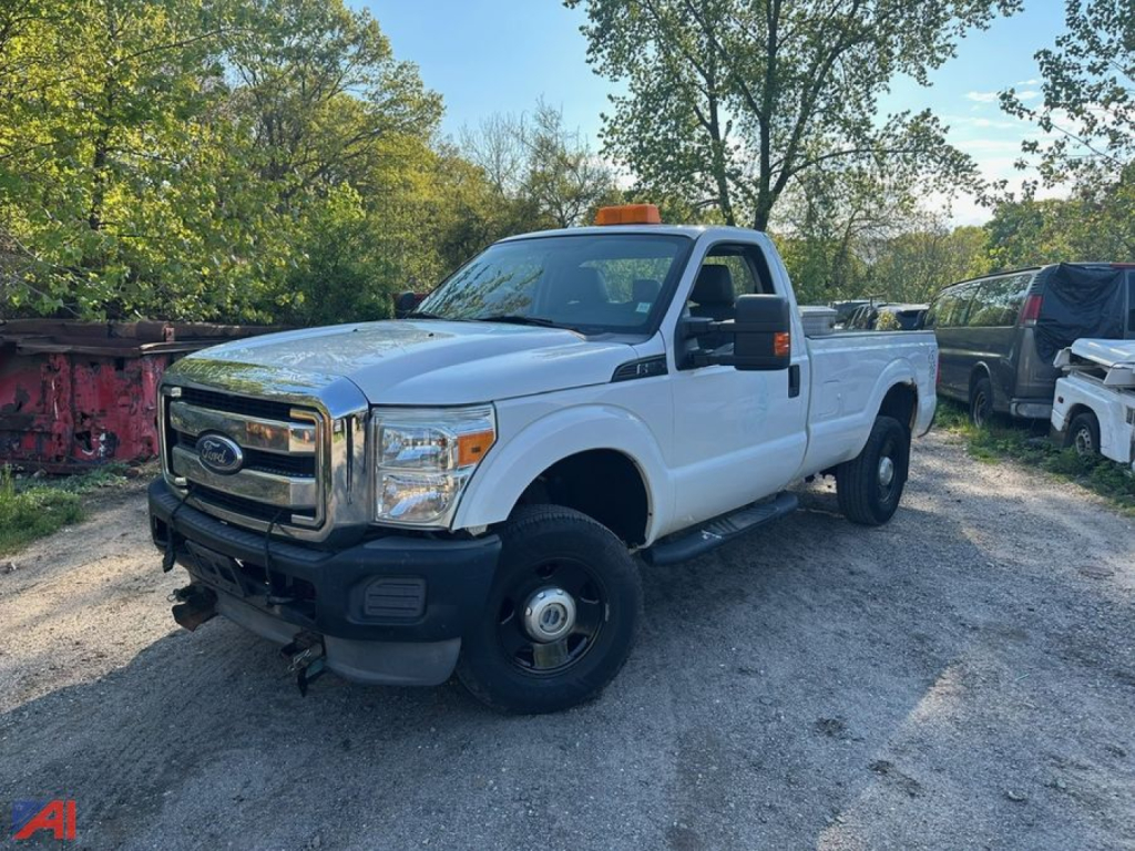 Ford F-250 Super Duty pickup truck in light color, extended cab/regular cab with utility bed in a used lot, front grille and bumper visible.