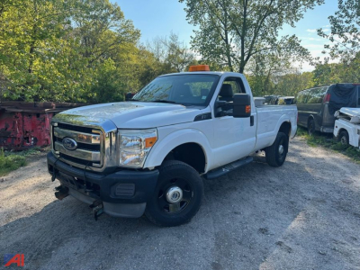 Ford F-250 Super Duty pickup truck in light color, extended cab/regular cab with utility bed in a used lot, front grille and bumper visible.