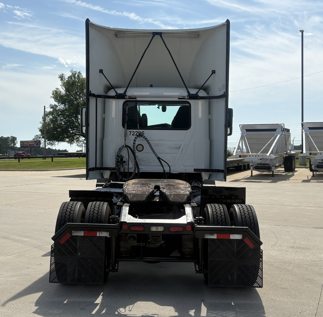 Rear view of a 2022 Mack AN42T daycab truck showing chassis, dual rear axles, and mudflaps with bumper lights.