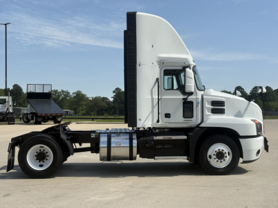 Side view of a 2022 Mack AN42T conventional daycab truck showing cab, fuel tanks, and chassis without trailer.