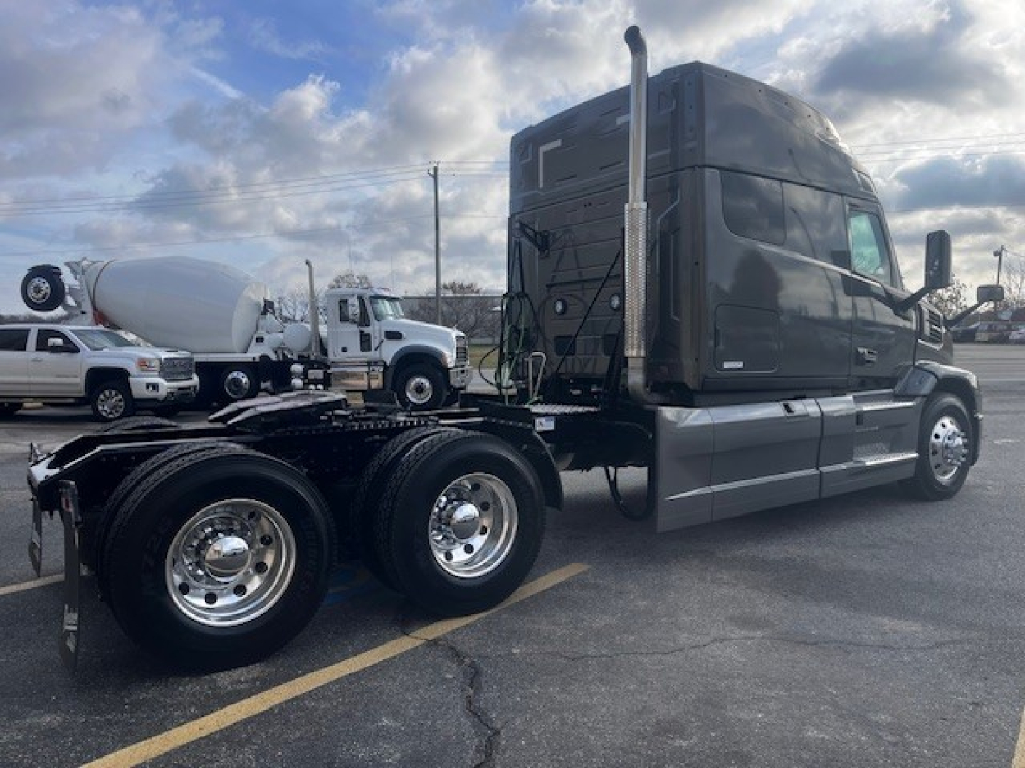2026 Mack PR64T76M truck tractor side/back view showing cab with tall exhaust stacks and dual rear axles.